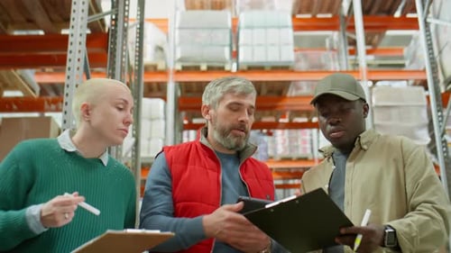 Group of Multiethnic Colleagues Cooperating in Warehouse