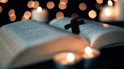 Open Book with Cross and Candlelight