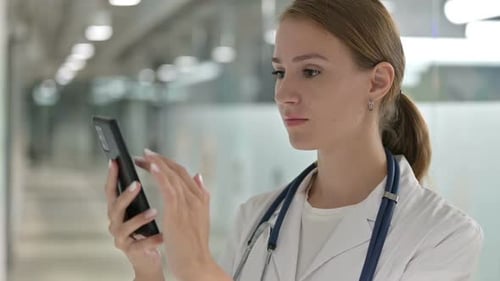 Doctor Using Smartphone in Hospital Setting