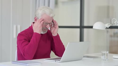 Senior Man Experiencing Eye Strain While Using Laptop