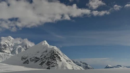 Clouds drift over snow-capped peaks in Denali National Park, Alaska, USA