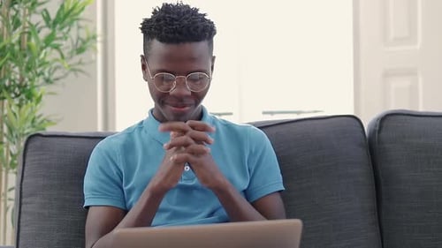 Man Celebrates Good News on Laptop at Home