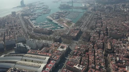 AERIAL: Barcelona Wide Drone Shot of City Towards Beautiful Blue Ocean and Bay