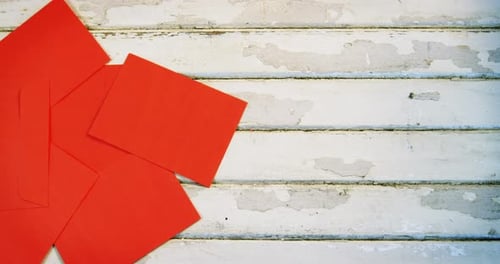 Overhead of Red Stationery on White Wooden Surface