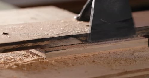 Woodworker cutting a piece of wood using a jigsaw