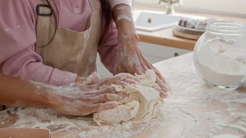 Unrecognizable Mom And Little Daughter Kneading Dough In Kitchen Closeup