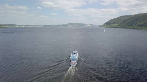 Aerial View of Moving Motor Ship on Wide River in Sunny Day, Following Boat