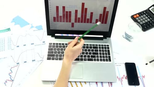 Business Peoples Developing a Business Project and Analyzing Market Data Information on a Laptop