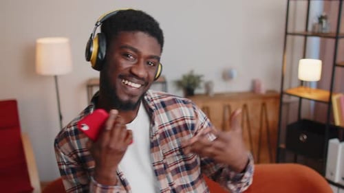 Young Man Dancing with Smartphone and Headphones