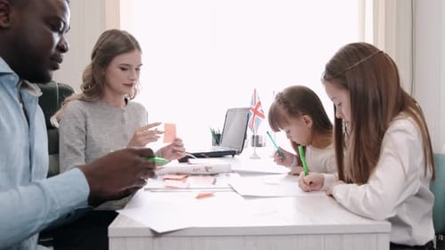 African American Teacher Teaching English Two Primary School Girls