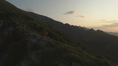 Lone Figure Enjoying Majestic Mountain Sunset