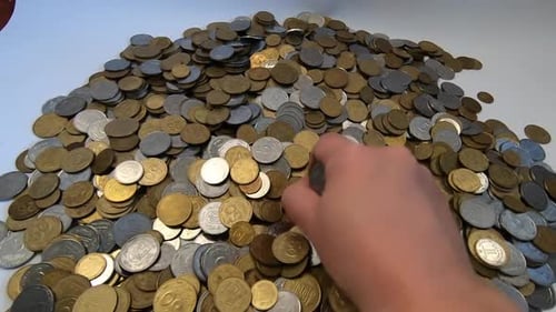 Hand Picking Up Coins and Dropping Them