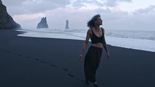 Cool Girl Walking Along Black Sand Beach