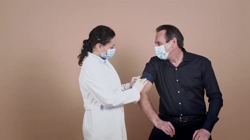 Man Receives Vaccine Injection from Medical Professional