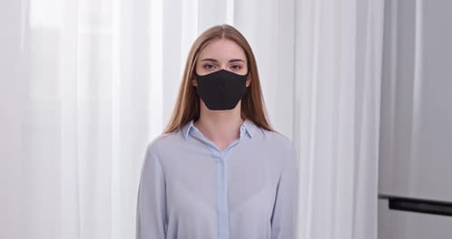 Woman Wearing Mask Indoors in a Room