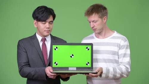 Two Men Holding Laptop With Green Screen