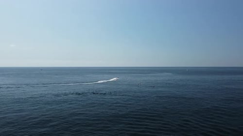 Aerial View of Motorboat and Paddleboarders on Ocean