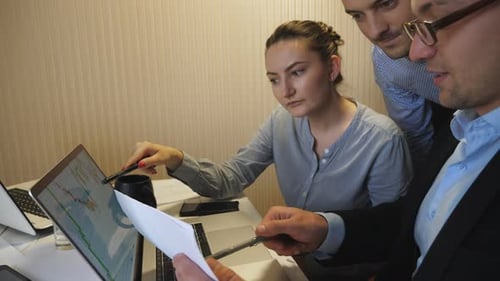 Business Team Reviewing Data and Documents Together