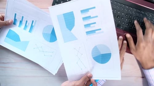 Unrecognized Young People Analyzing Bar Chart on Paper