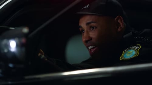 Police Officer with Gun at Night in Patrol Car