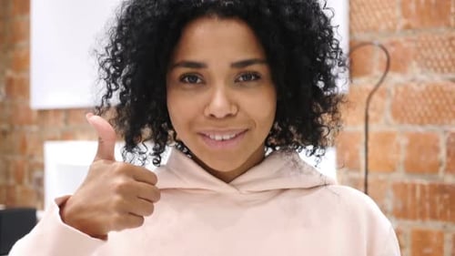 Smiling Woman Gives Thumbs Up Approval