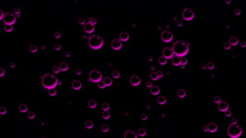 Oil pink drops moving in water