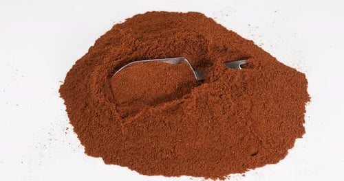 Red Powder with Silver Scoop on White Background