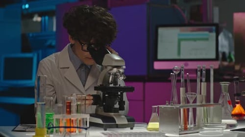 Scientist Works With Microscope in Lab