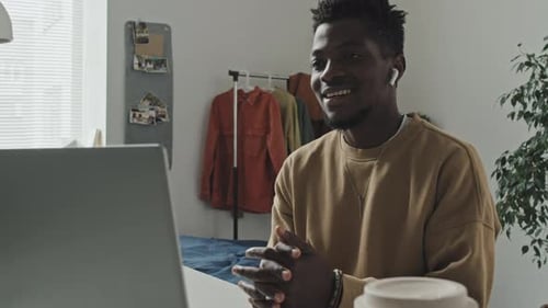 Young Adult Having a Video Conference Call at Home