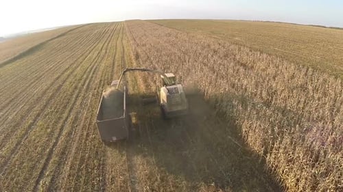 Harvesting crops on vast farmlands, aerial view