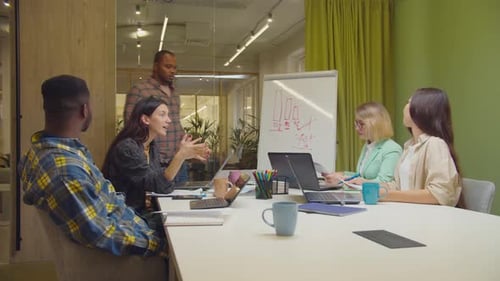 Enthusiastic Team Celebrates Success in Modern Office