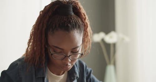 Woman Writing at Table at Home with Pie