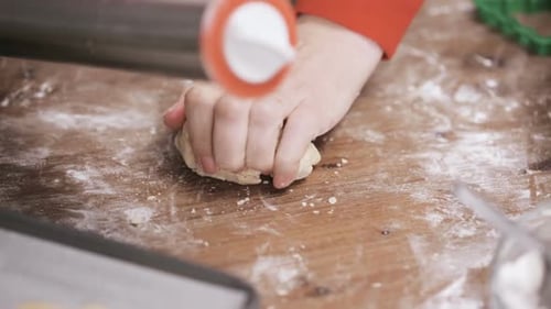 Hands Rolling Dough, Christmas Cookies on Wooden Table