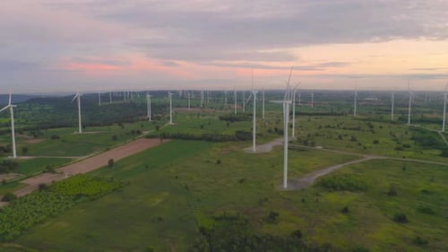 Aerial view of wind turbines or windmills farm field in industry factory. Power, sustainable green