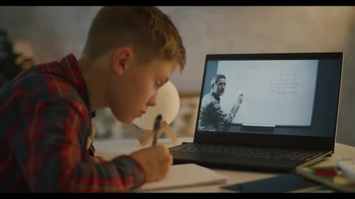 Child Doing Schoolwork During Online Lesson