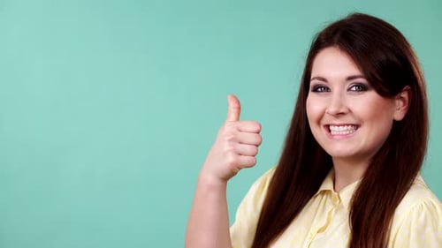 Smiling Woman Gives Approval Thumbs Up