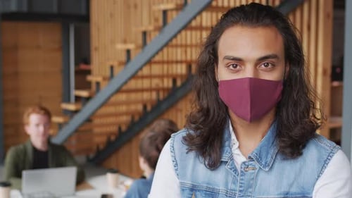 Portrait of Young Businessman in Face Mask in Office