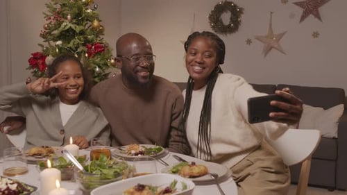 Happy Family of Three Taking Selfie at Christmas