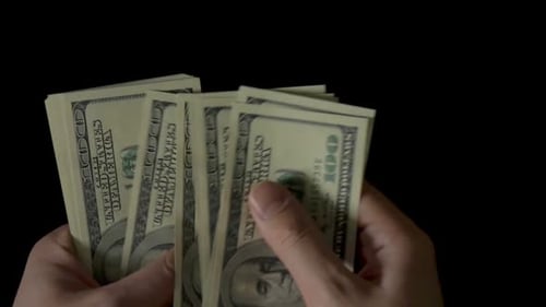 Male Hands Counting Money, One Hundred Dollar Bills on Black