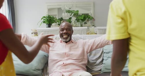 Loving Grandfather Receives Warm Hugs from Grandchildren