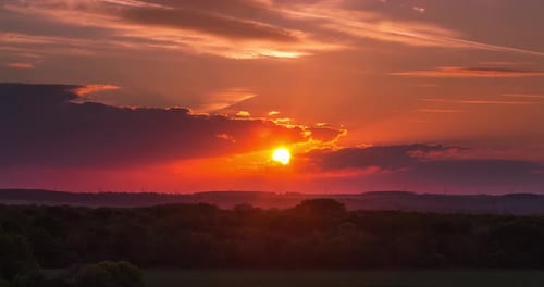 Vibrant Sunset Time-Lapse Over Rural Landscape