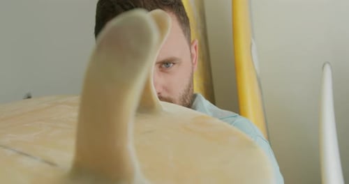 Male surfboard maker in his workshop