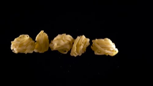 Raw Pasta Falling in a Close Up Shot