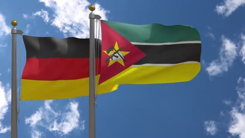 Waving Flags of Germany and Mozambique on Flagpoles