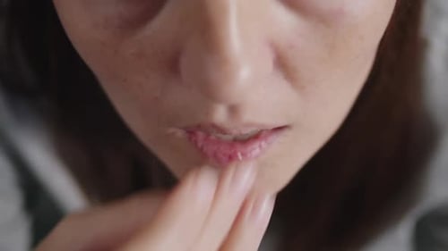 Close Up of a Woman Taking a White Magnesium Pill and Drinking Water