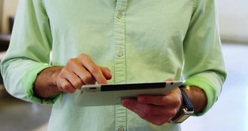 Man Using Tablet Computer at Work, Close-Up