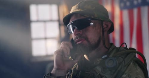Man in Military Gear Using Walkie Talkie