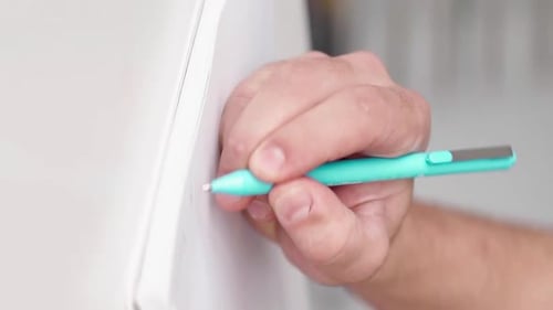 Hand Writing Notes with Pen in Notebook