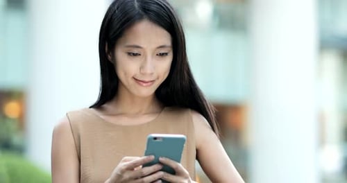 Business woman use of smart phone in the city