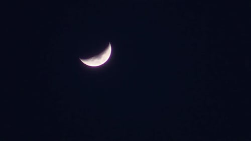 Crescent Moon Shines in Night Sky